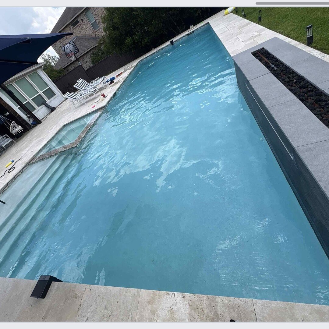 Modern infinity-edge pool with dark coping